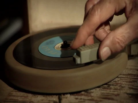Vintage record player playing 45 vinyl record with old mans hand Stock Footage 45532471