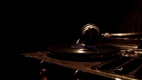 Vintage record player stands in dark room playing music Stock Footage 329559906