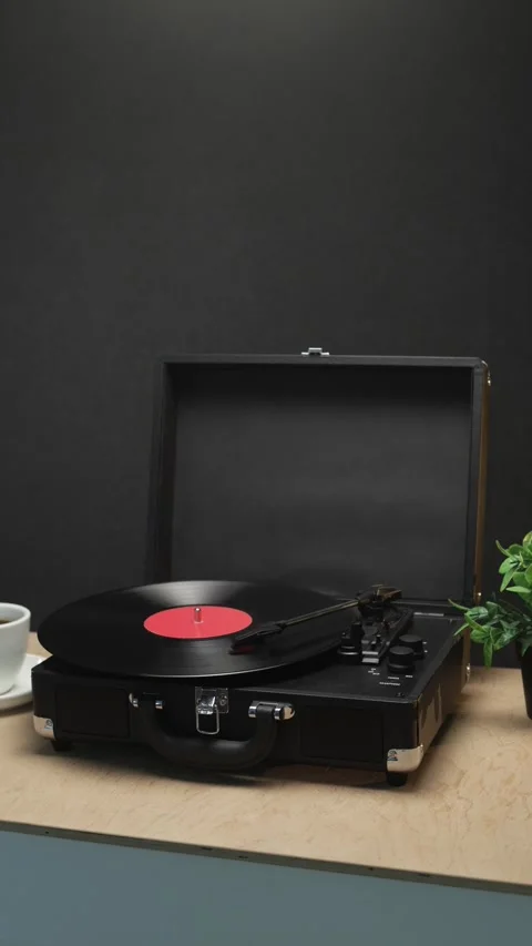 Vintage record player with vinyl disc and coffee cup on a wooden surface Stock Footage 340844688