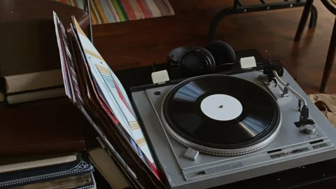 Vintage Record Player, Vinyl Discs, Headphones and Books in Charity Store Stock Footage 327810995