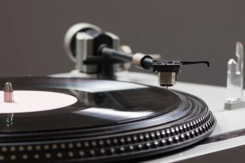 Vintage record player while recording, the record spins and music plays. Stock Photos