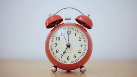 A vintage red alarm clock. The dial moves during one minute. Stock Footage 105347888