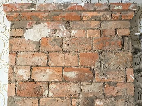 Vintage red brick fireplace structure with pattern wallpaper Fotos de archivo