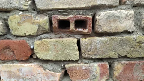 Vintage red bricks as building blocks: aged wall of an old building Stock Footage 212259312