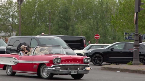 Vintage Red Convertible Driving Through Urban Paris Traffic Stock Footage 341908464