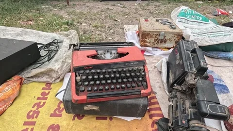 Vintage Red Mechanical Typewriter and Electronic Equipment Placed at Outdoor Stock Footage 346387783