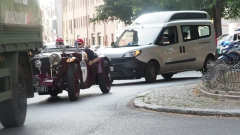 Vintage red MG Midget racing Mille Miglia, overtaking gray Fiat Doblo on Cr.. Stock Footage 312201907