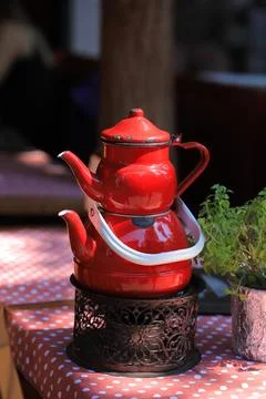 Vintage red teapots on the table Stock Photos