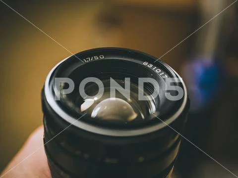 Vintage retro lense camera objective photography macro in the hand. Stock Photos