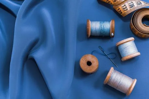 Vintage retro spool of thread on a black and white fabric background. Needle Stock Photos