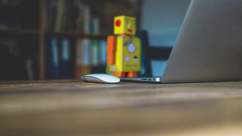 Vintage Robot in front of Notebook Machine Learning concept 4k Video stock 82550708