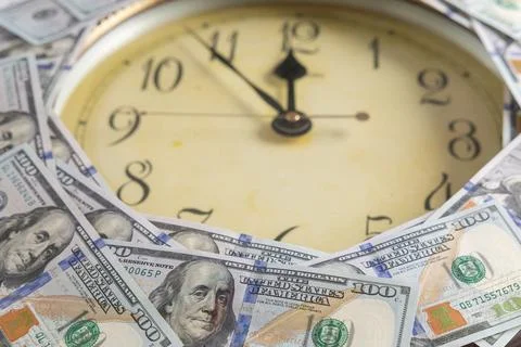 Vintage round wall clock framed with US one hundred dollar bills concept of.. Stock Photos