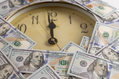 Vintage round wall clock framed with US one hundred dollar bills concept of.. Stock Photos