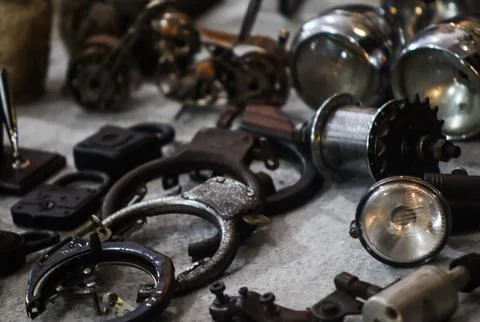 Vintage rusty bicycle locks headlights and mechanical parts collected on tabl Stock Photos