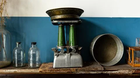 Vintage Scale on Rustic Shelf with Old Bottles and Metal Bowl in a Charming Stock Photos