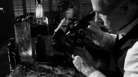 Vintage scientist looking through microscope Stock Footage