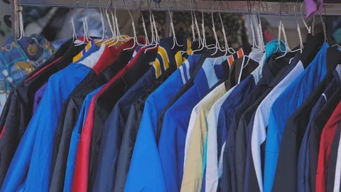 Vintage second hand hat and clothes rail showing colourful vintage clothes on Stock Footage 122875145
