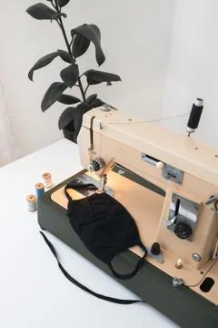 Vintage sewing machine the process of sewing a protective mask at home workplace Stock Photos
