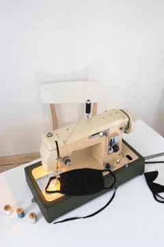 Vintage sewing machine the process of sewing a protective medical mask at home Stock Photos