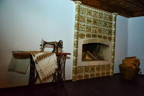 Vintage sewing machine in a rustic interior with fireplace Stock Photos