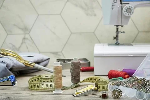Vintage Sewing Studio Setup With White Sewing Machine, Scissors, Thread Spools Stock Photos