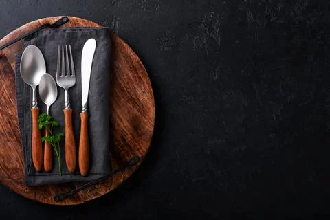 Vintage silverware. Rustic vintage set of wooden spoon and fork on wooden pla Stock Photos
