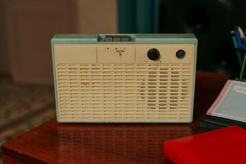 Vintage Soviet three program wired radio speaker on wooden desk Stock Photos