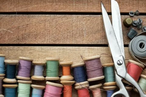 Vintage spools of multicolored threads, tailoring scissors, thimbles.  Stock Photos