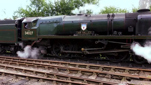 Vintage steam engine  pulling passenger carriages Stock Footage 80317829