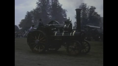 Vintage steam traction engine moving at rural fair in the 1960s Stock Footage 313724923
