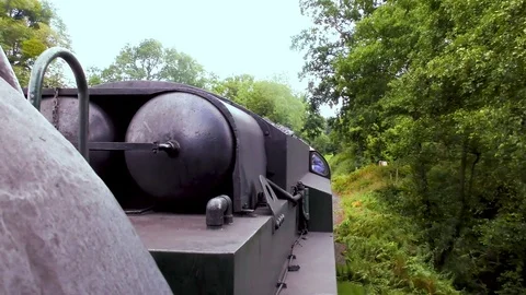 Vintage steam train producing smoke travelling through countryside Stock Footage 80305860