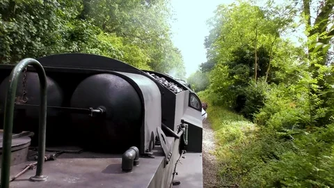Vintage steam train producing smoke travelling through countryside Stock Footage 80309791