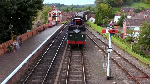 Vintage steam train producing smoke country railway station Stock Footage 80310975