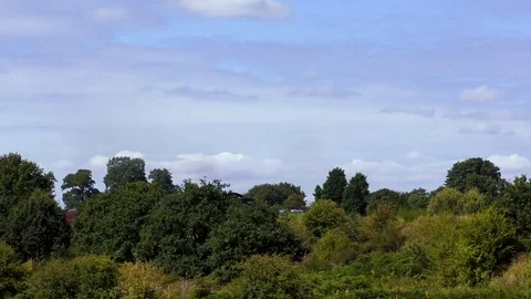 Vintage steam train producing smoke travelling through countryside Stock Footage 80332968
