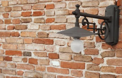 Vintage street lamp on red brick wall of building Stock Photos
