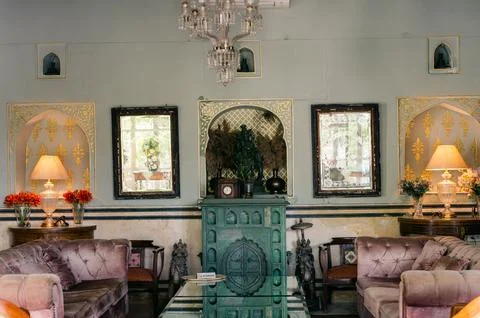 Vintage-style interior with pink sofas and an old chandelier Stock Photos