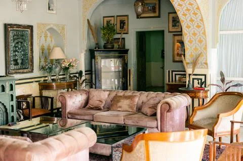 Vintage-style interior with pink sofas and an old chandelier Stock Photos