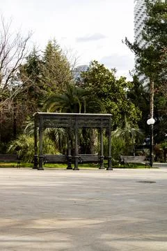 Vintage-style park swings and benches in a lush tropical park in Sochi Stock Photos