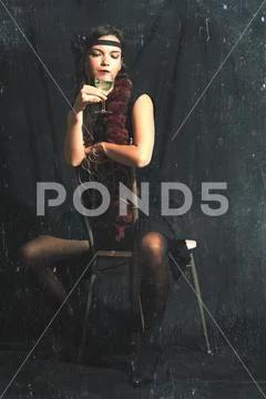 Vintage style photograph with created artifacts of a 30s style woman with alc Stock Photos