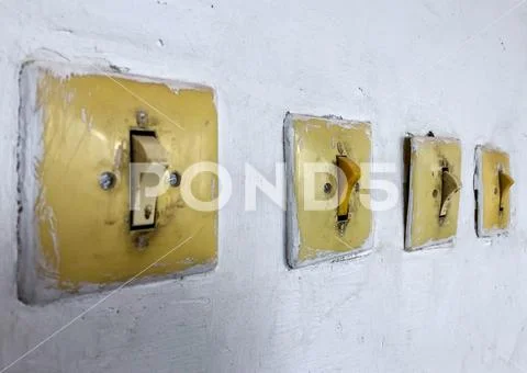 Vintage switch and light switch on the wall. Stock Photos