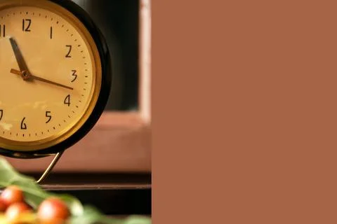 Vintage table clock and apple tree leaves with small apples on wooden backg.. Stock Photos