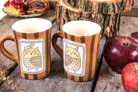 Vintage table set with cups of tea cookies and apples Stock Photos