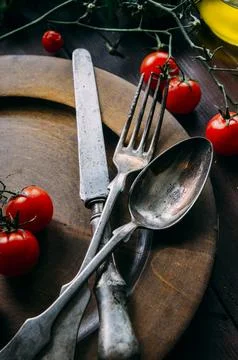 Vintage table setting with old silver spoon, fork and knife in dark wooden .. Stock Photos