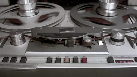 Vintage reel-to-reel tape recorder with spinning reels was made in