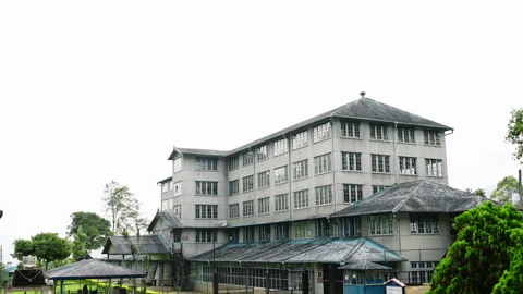 Vintage tea factory processing unit, surrounded by green plants, operates Stock Footage 274937329