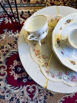 Vintage Tea Set on Decorative Table with Oriental Rug Stock Photos