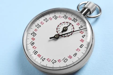 Vintage timer on light blue background, closeup. Measuring tool Stock Photos