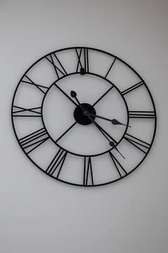 Vintage timer Old big Black Clock in wall interior with roman numerals Foto stock