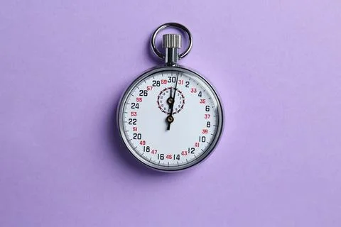Vintage timer on violet background, top view Stock Photos