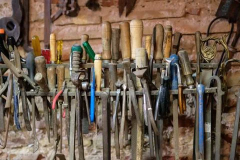 Vintage Tools Hanging On A Wall In A Tool Shed Or Workshop Stock Photos